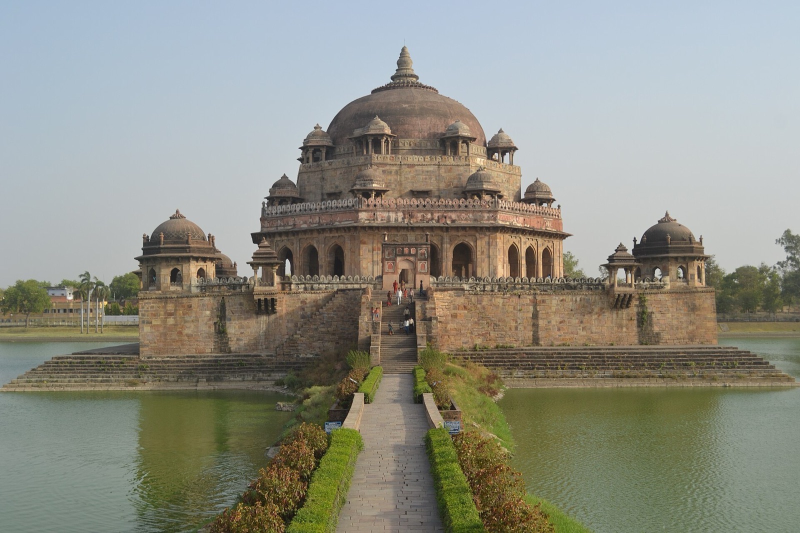 The domed red sandstone tomb of Sher Shah Suri rising from a lake at Sasaram